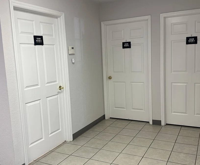 Supreme CHS private exam room corridor with Exam Room 1, 2, and 3 doors